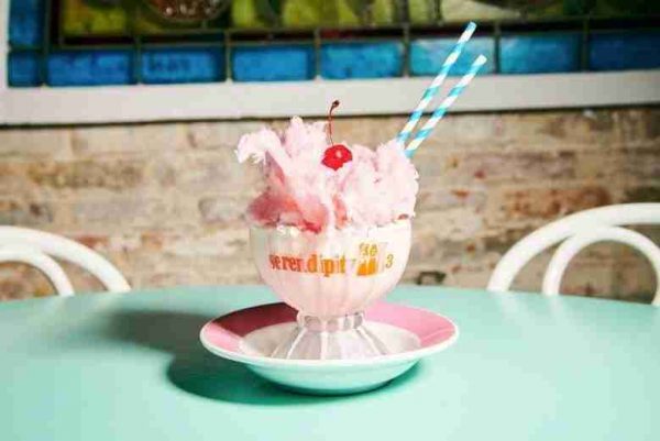 Serendipity3's newest Frrrozen Hot Chocolate flavor features ​​a Creamy, Dreamy Pink Cotton Candy flavored White Chocolate, Topped with a Mountain of Whipped Cream, a Fluffy Twirl of Cotton Candy and a Cherry on Top